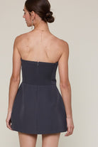 Back view of the Sky to Moon Lara charcoal strapless romper dress showing the stretchy smocked panel and hidden zipper