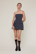 Model wearing Sky to Moon Lara charcoal strapless romper dress for graduation or sorority rush