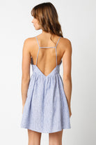 Back view of blue striped linen babydoll dress with criss-cross cami straps
