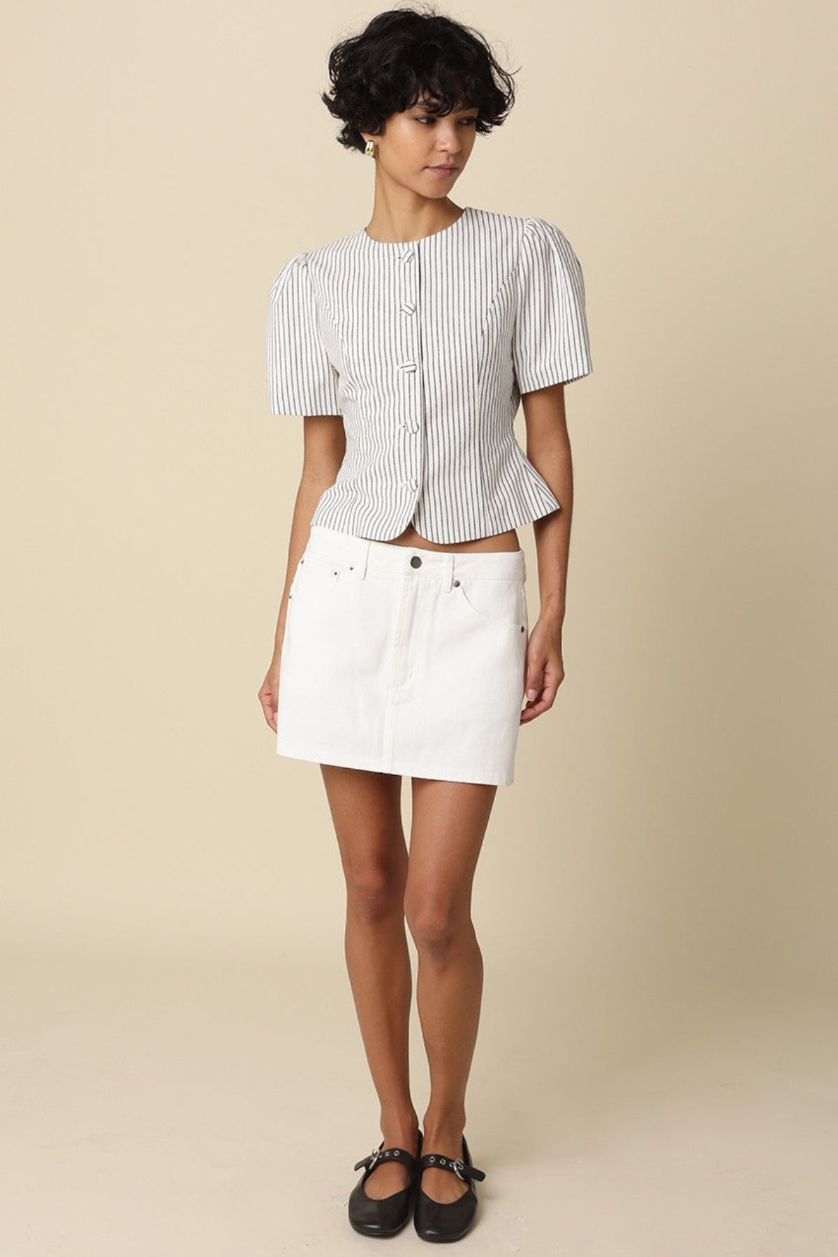 model wearing the white and black stripped puff sleeve top