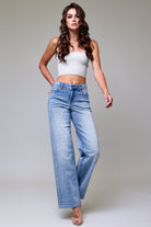 Monica light wash dad jeans styled with heeled boots and a white tee for a 90s model-off-duty look.