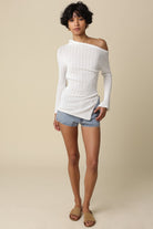 Angled shot of the Monika top highlighting the sheer fabric and draped silhouette