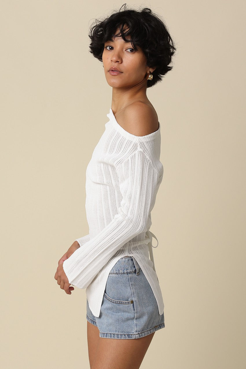Side view of the white Monika top showing the high slit at the hem