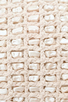 crochet and pearl clutch close up view