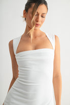 Close-up of square neckline and wide straps on the Savanna white maxi dress