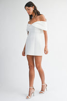 Model walking in the Tina dress to show the mini skirt