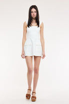 Structured white denim mini dress with a smocked back.