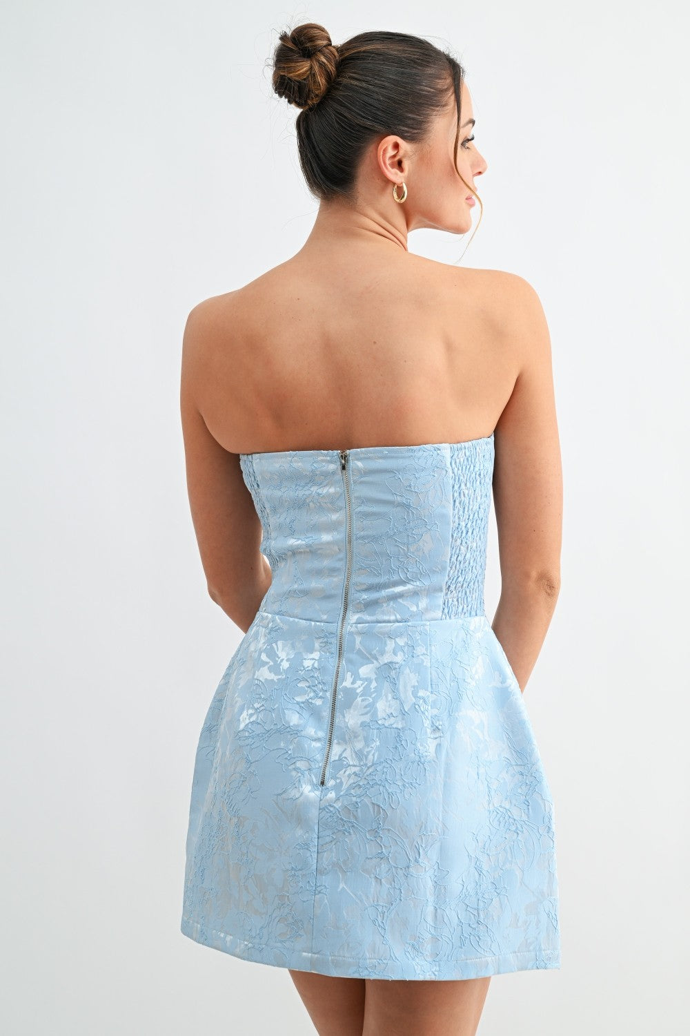 Back view of blue strapless dress showing zipper closure