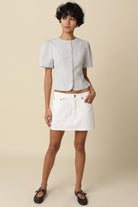 white and black stripped puff sleeve top styled with a white mini skirt