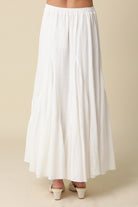 Full-length white textured godet skirt for women with an elasticated waistband.