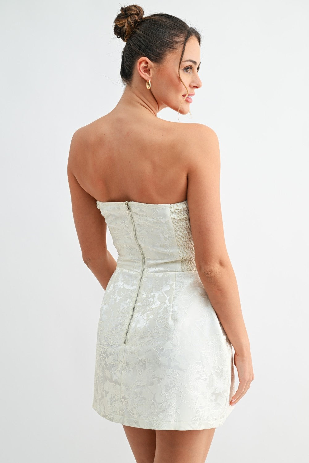 Back view of white strapless dress showing zipper closure